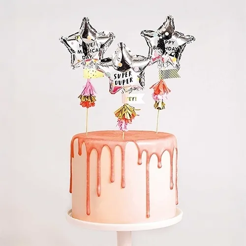  celebratory cake, pink drip cake, metallic star toppers, birthday cake, fondant cake